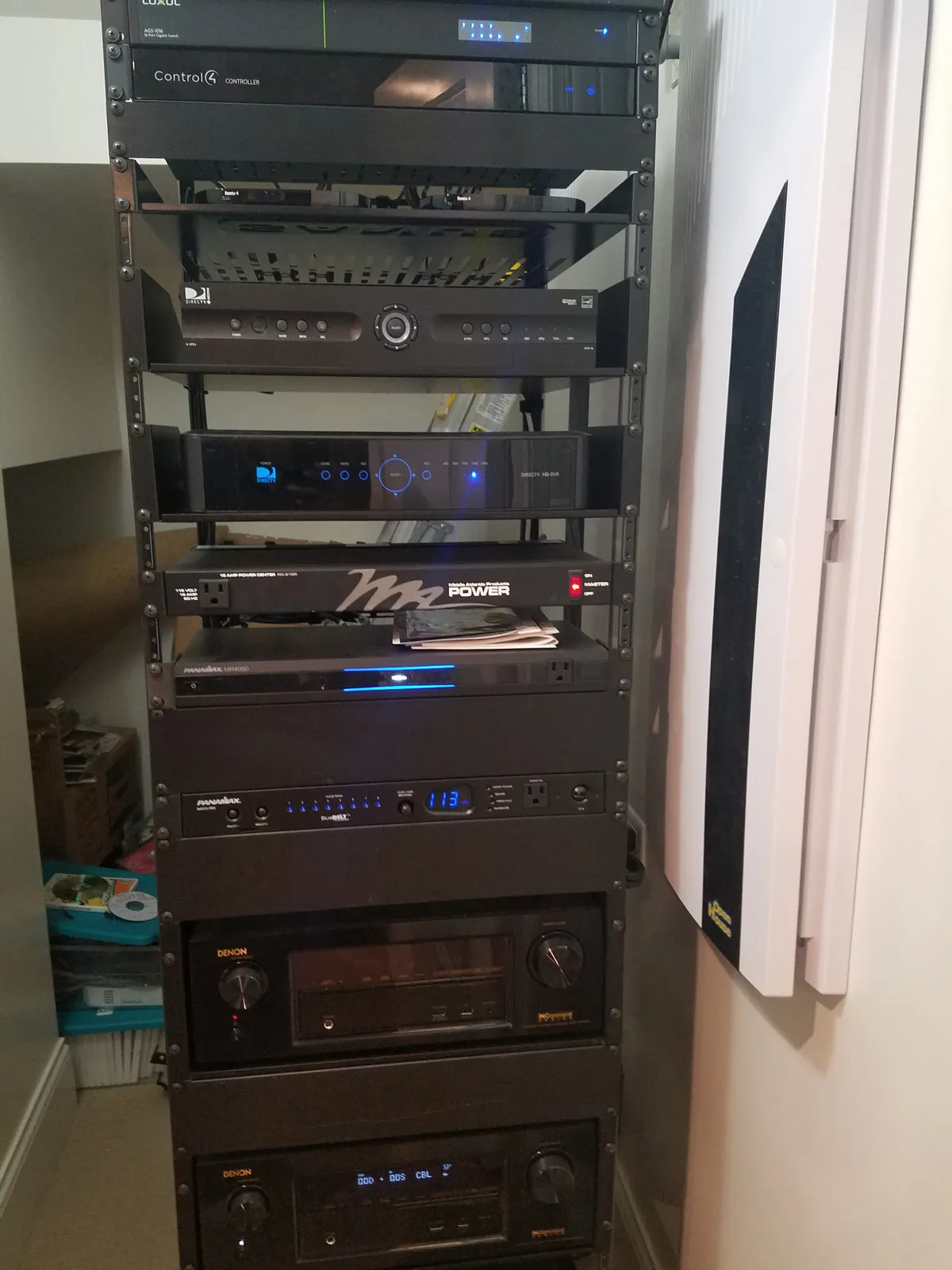 Floor-standing equipment rack holding a Control4 controller, network switch, receivers, and power conditioners.